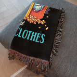 Blanket with colorful design and text on a gray surface