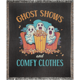 Blanket with cartoon ghosts eating popcorn and text 'Ghost Shows and Comfy Clothes' on a dark background.
