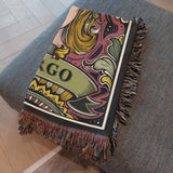 Decorative throw blanket with colorful design and 'VIRGO' text on a gray surface.